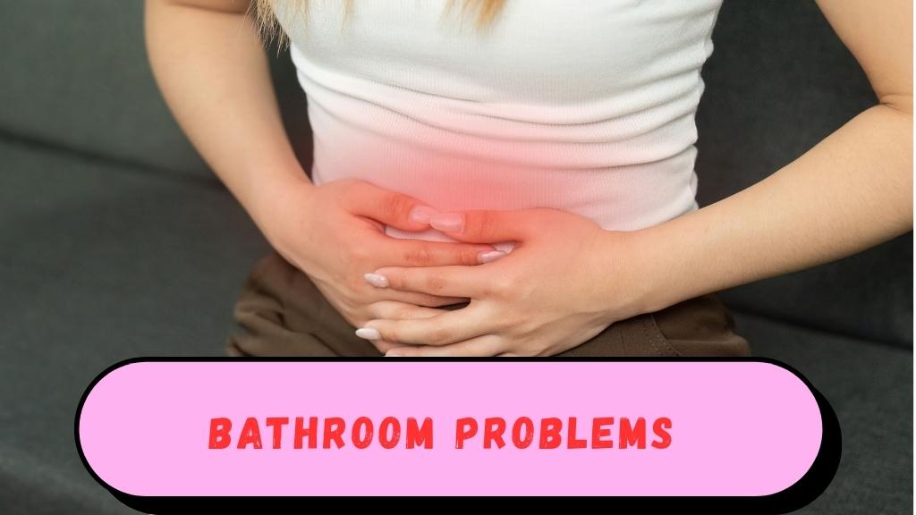 Person holding their stomach in discomfort, sitting on a couch or at a table, with subtle hints of digestive issues like bloating, indicating weak gut immunity.