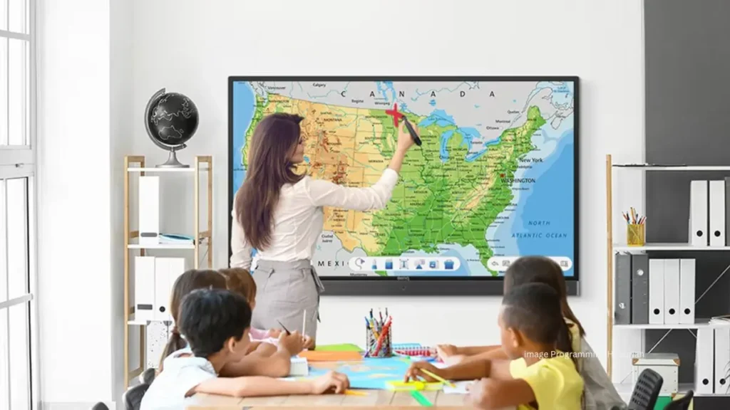 A teacher using an interactive map in the classroom with students. JR Geo makes geography lessons fun and engaging for US schools.