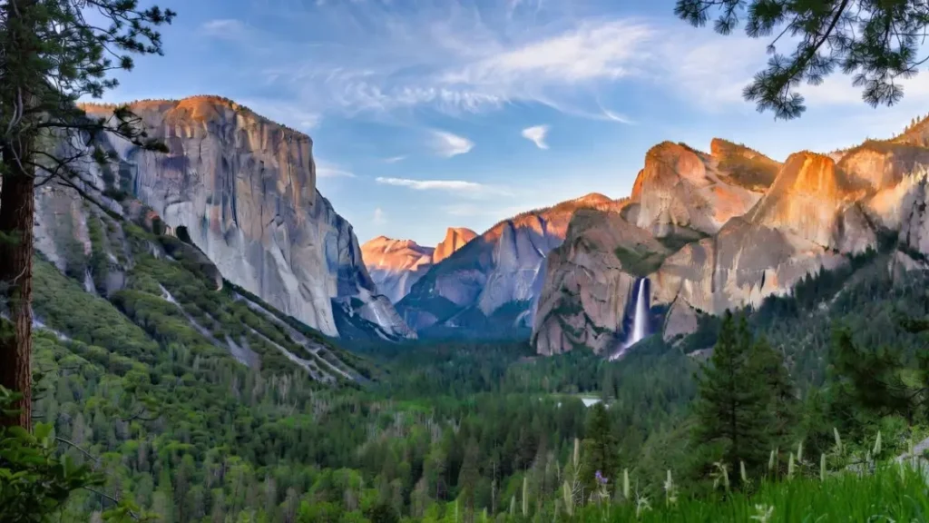 Yosemite National Park in spring with powerful waterfalls at peak flow from snowmelt, lush green valley, Mirror Lake reflecting Half Dome
