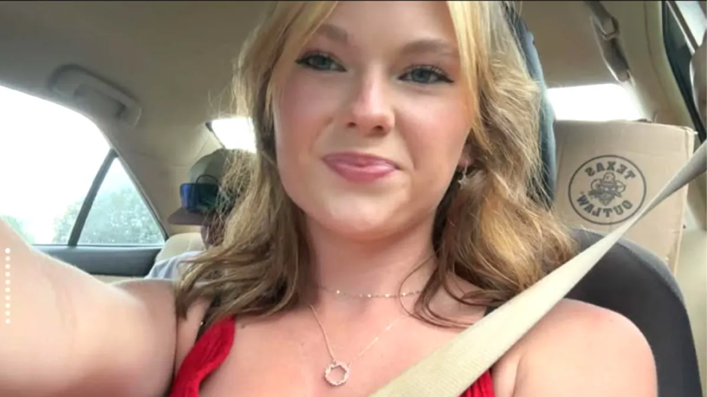 Selfie-style in red top inside a car